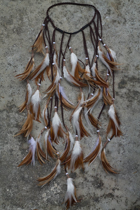 Brown and white headpiece with feathers