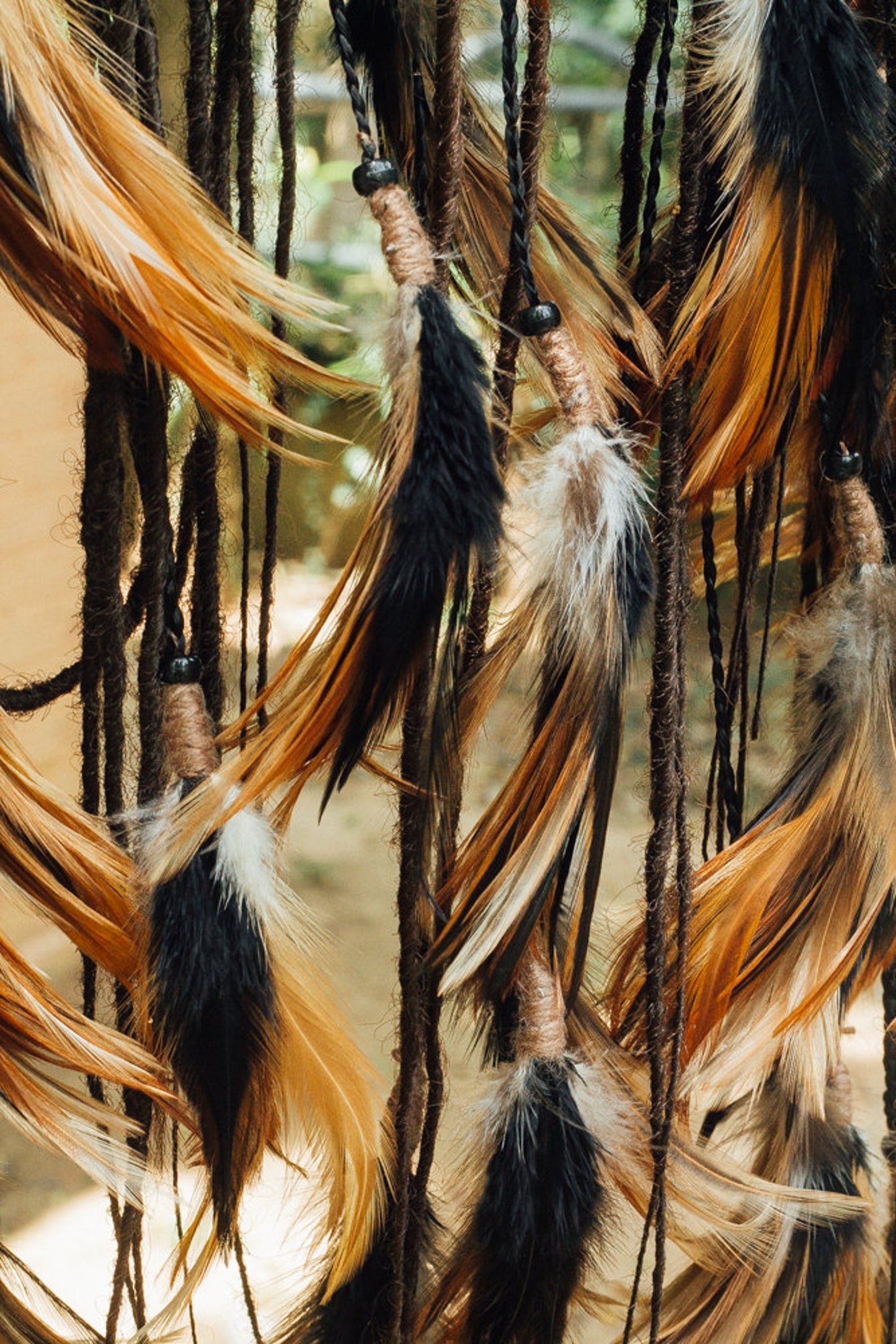 Black headpiece with feathers and added dreadlocks