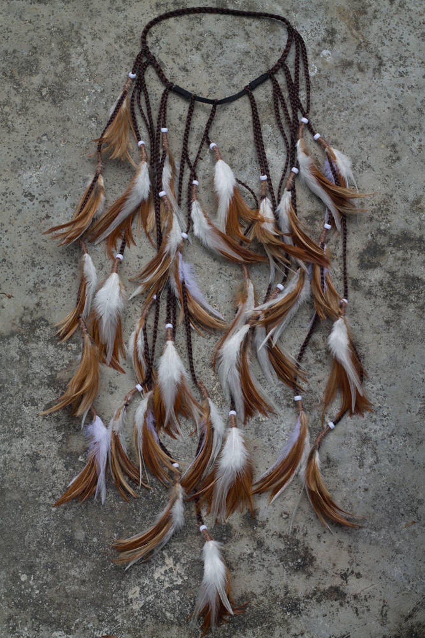 Brown and white headpiece with feathers