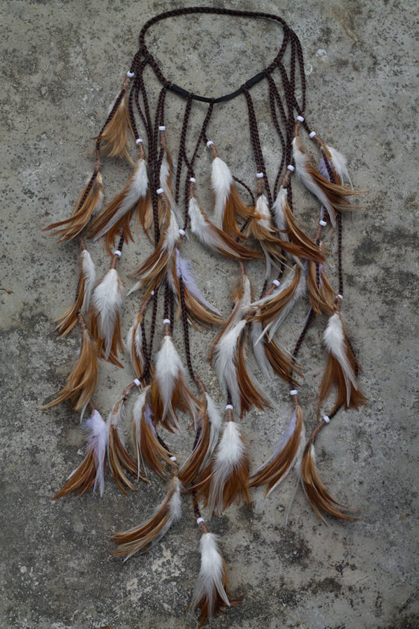 Brown and white headpiece with feathers