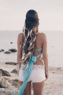 Brown and white headpiece with feathers