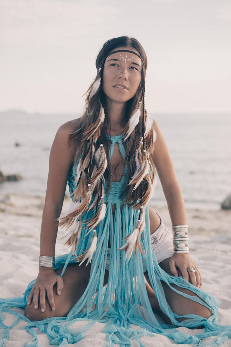 Brown and white headpiece with feathers