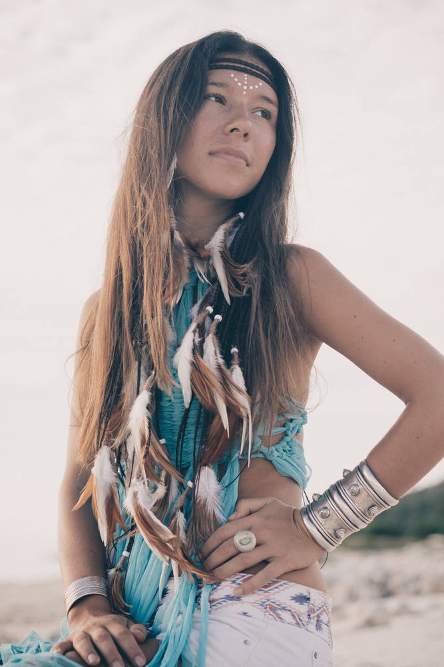 Brown and white headpiece with feathers