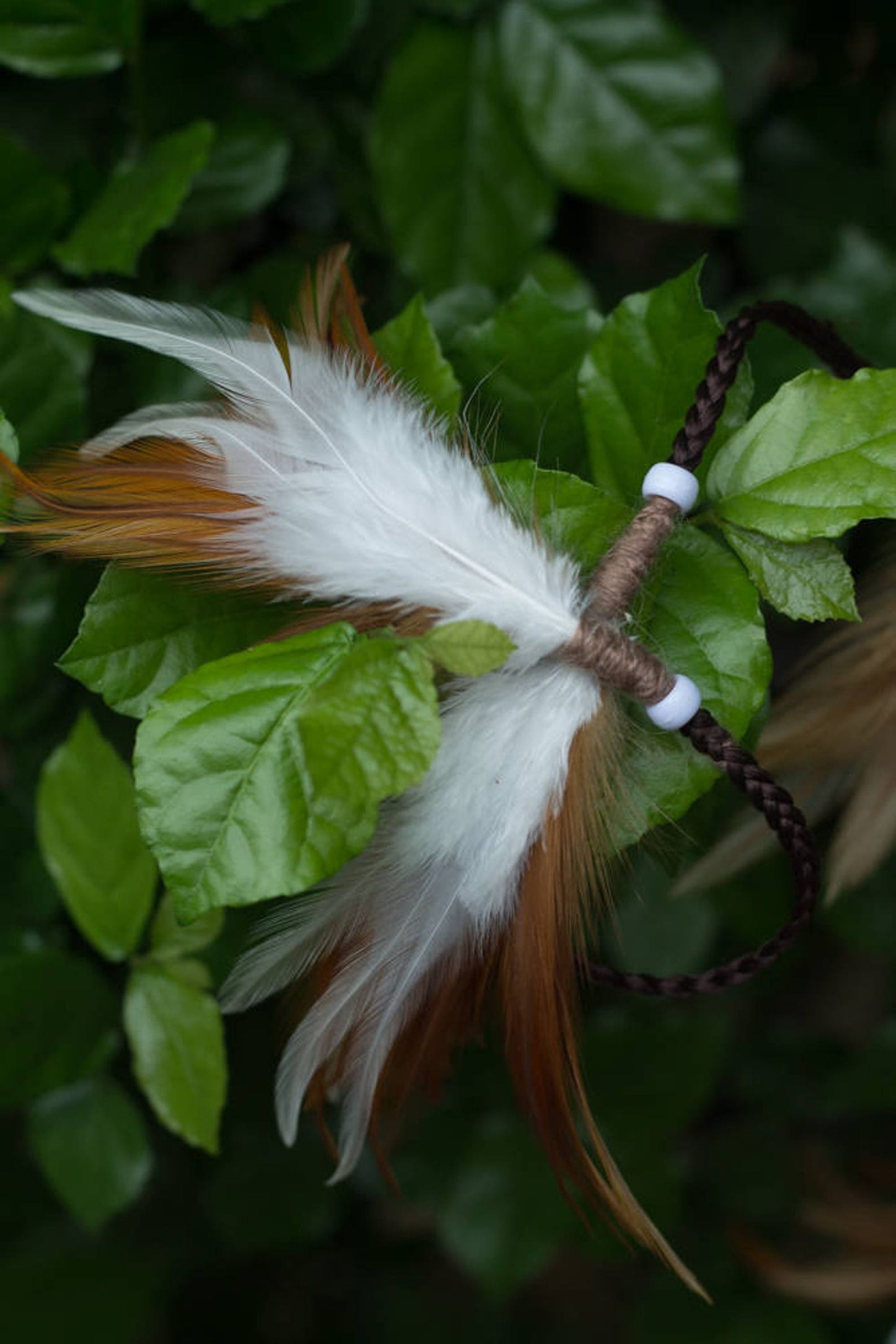 Brown and white headpiece with feathers
