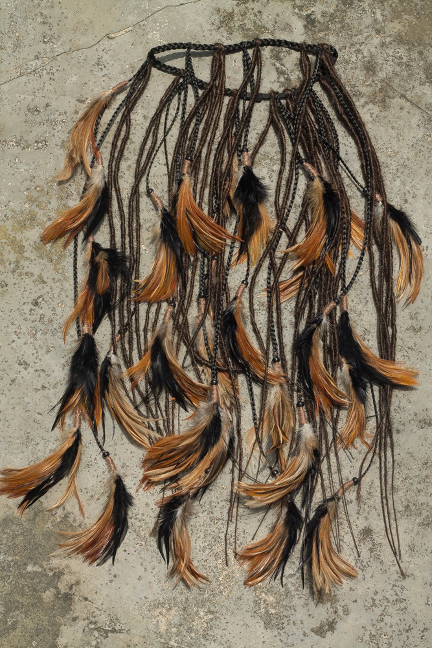 Black headpiece with feathers and added dreadlocks